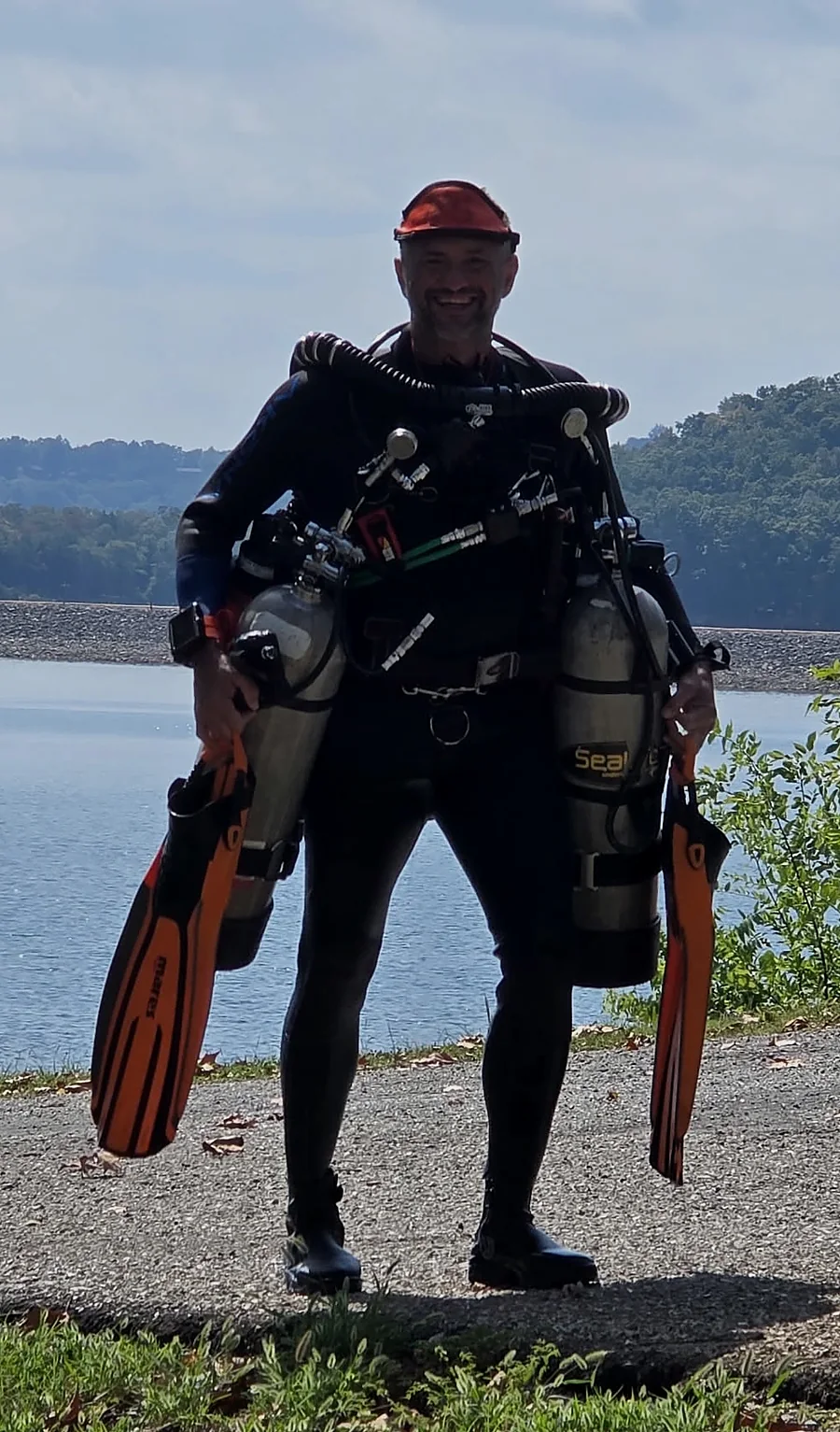 Steven wearing a KISS Sidewinder rebreather beside the water